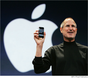 Steve Jobs holding iPhone smiling
